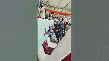 Japanese fan picking up German flag left on the seat - FIFA World Cup - Germany vs. Japan